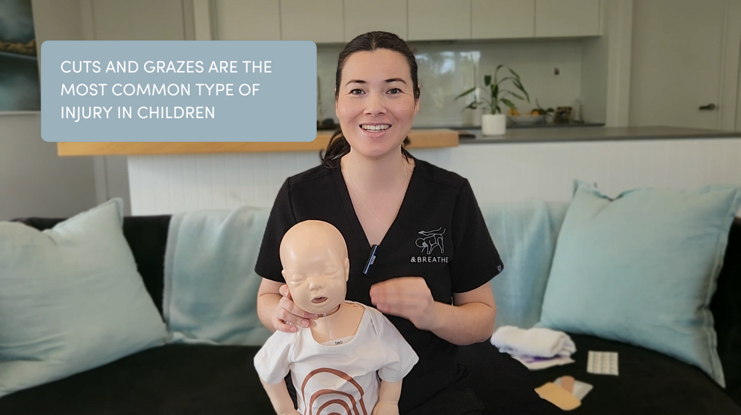 Person holding a mannequin with visible injuries in a home setting