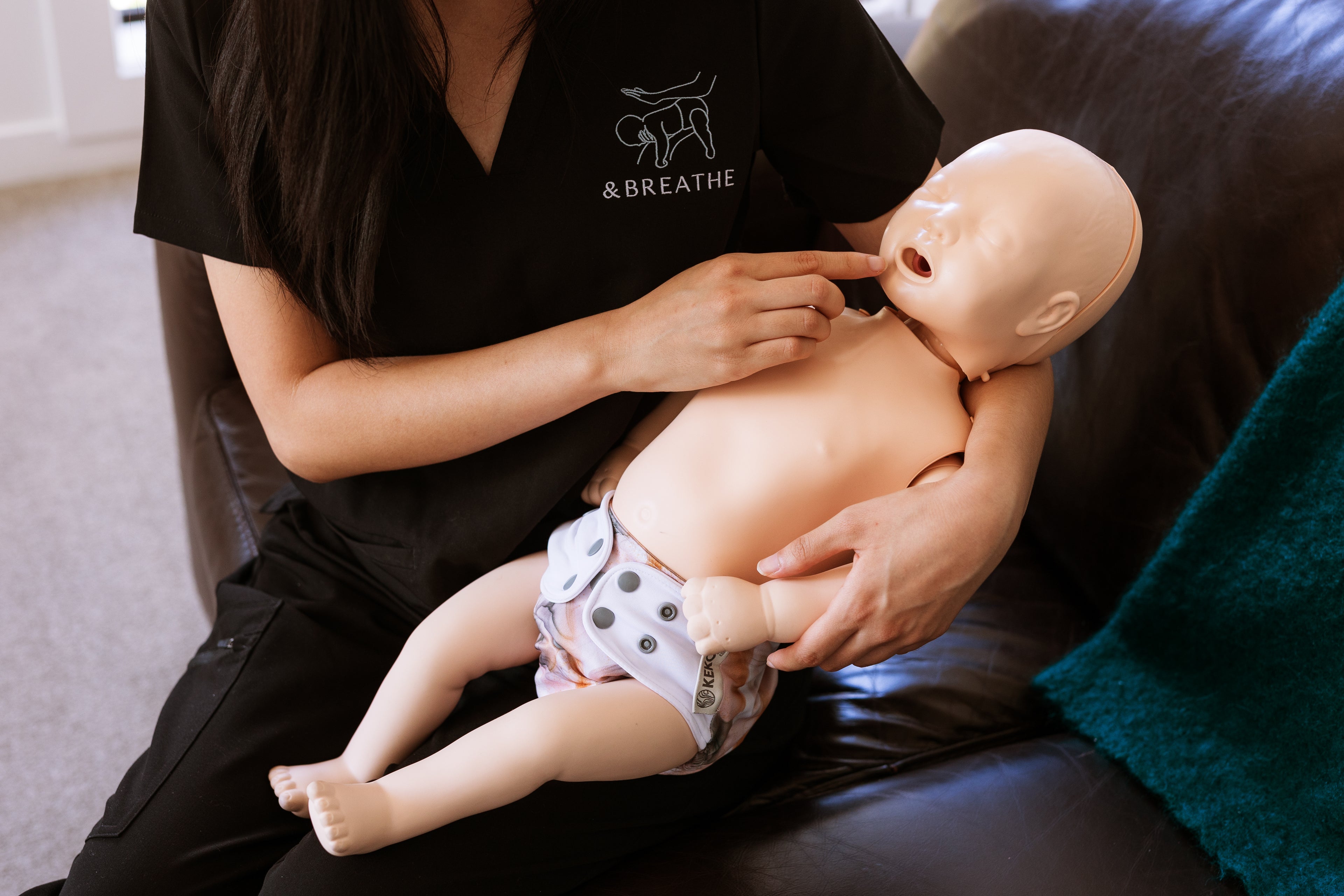 Person demonstrating CPR on a mannequin 